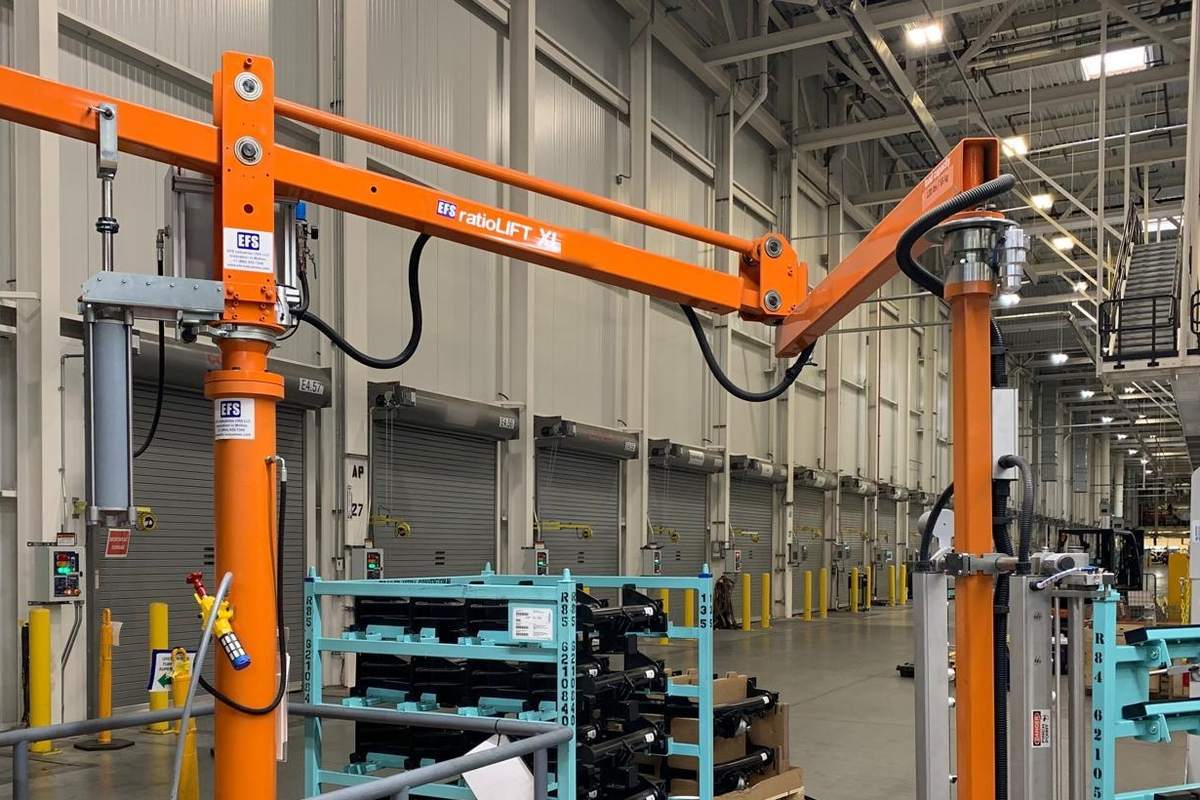 An EFS articulating arm device on a column, its jointed arm reaching across a plant aisle
