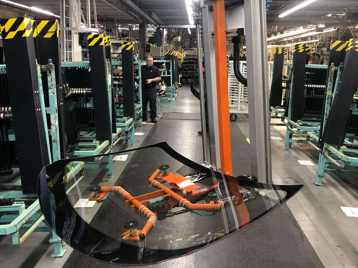 An EFS vacuum frame carrying an automotive windshield past racks of glass