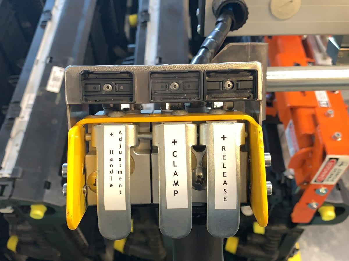 Labelled operator paddles for clamp, release and handle adjustment on an EFS manipulator